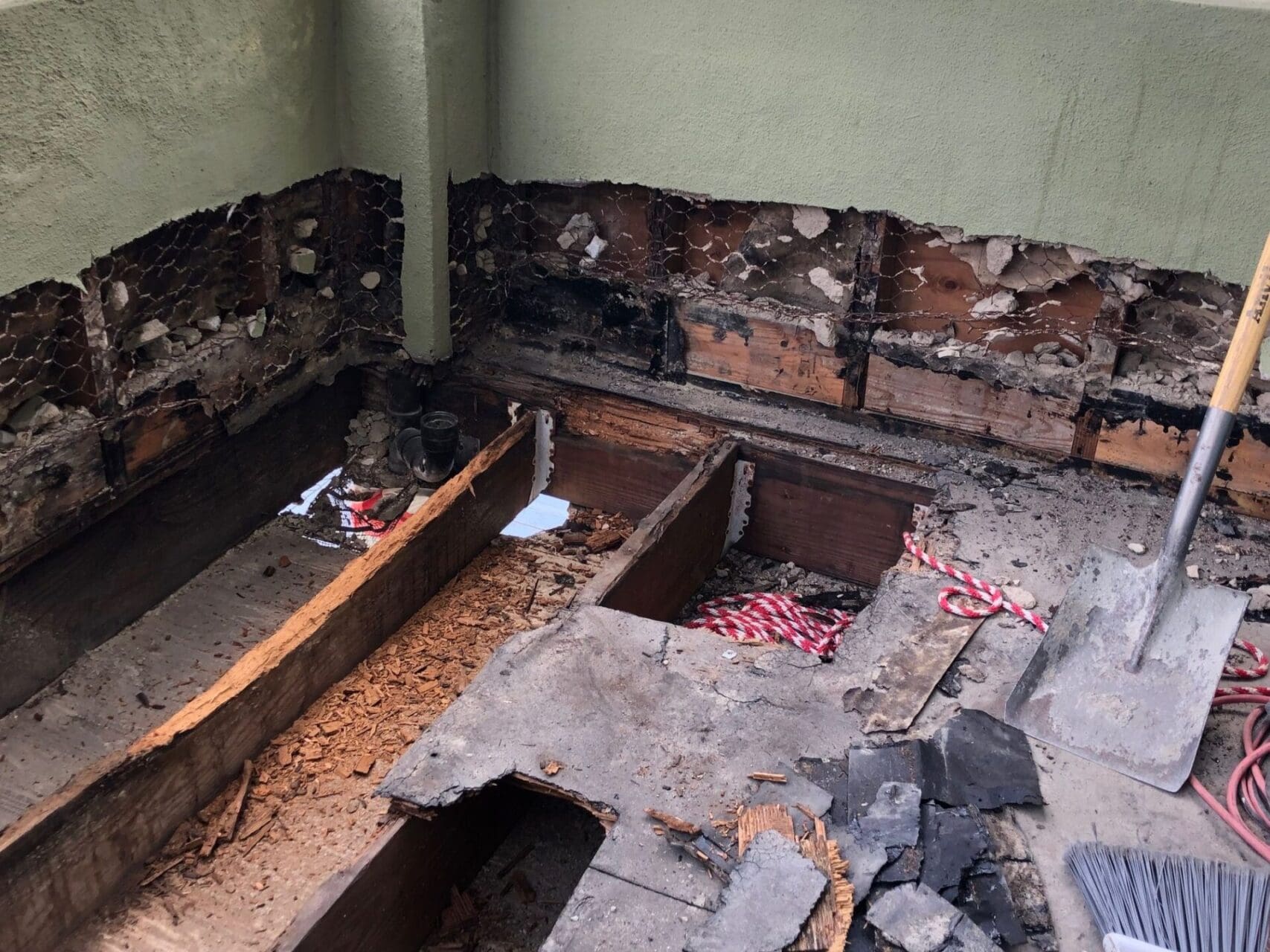 A room that has been demolished and the floor is being torn off.
